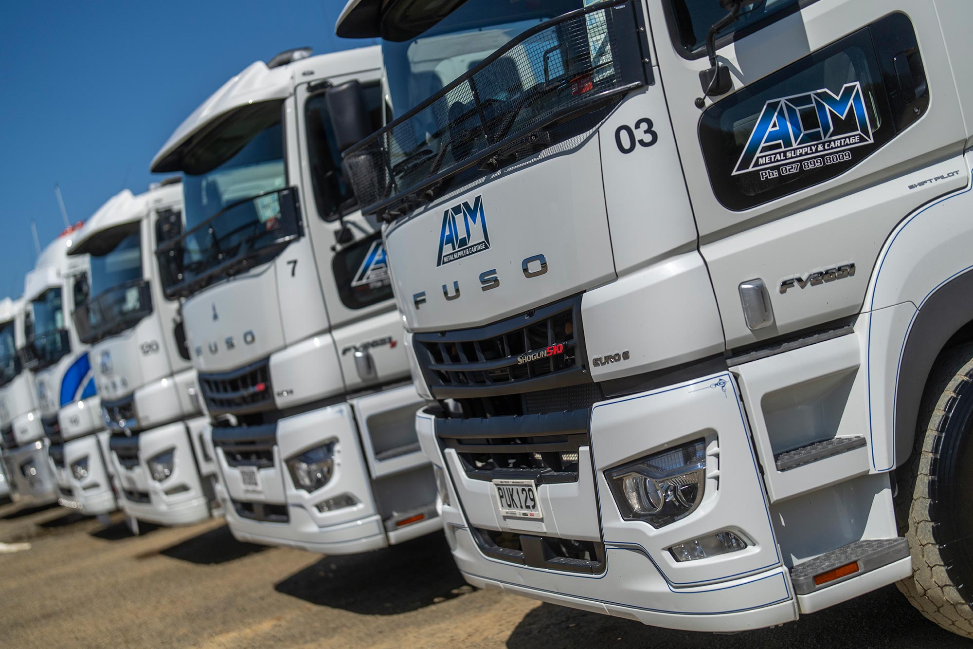 Close up of ACM Metal's FUSO trucks